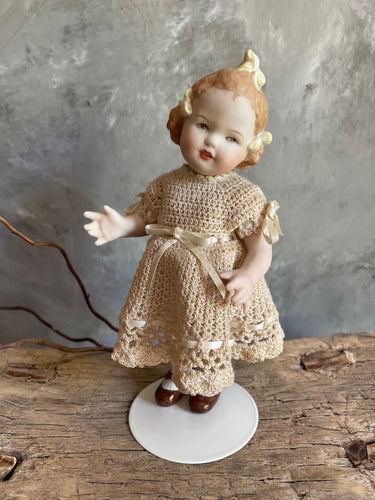 Bisque Porcelain Artisan Child’s Doll With Hand Crochet Clothing.